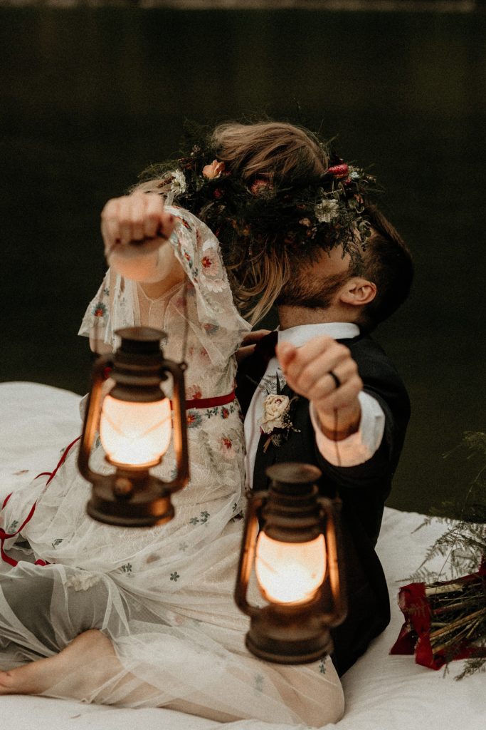bride and groom holding lanterns