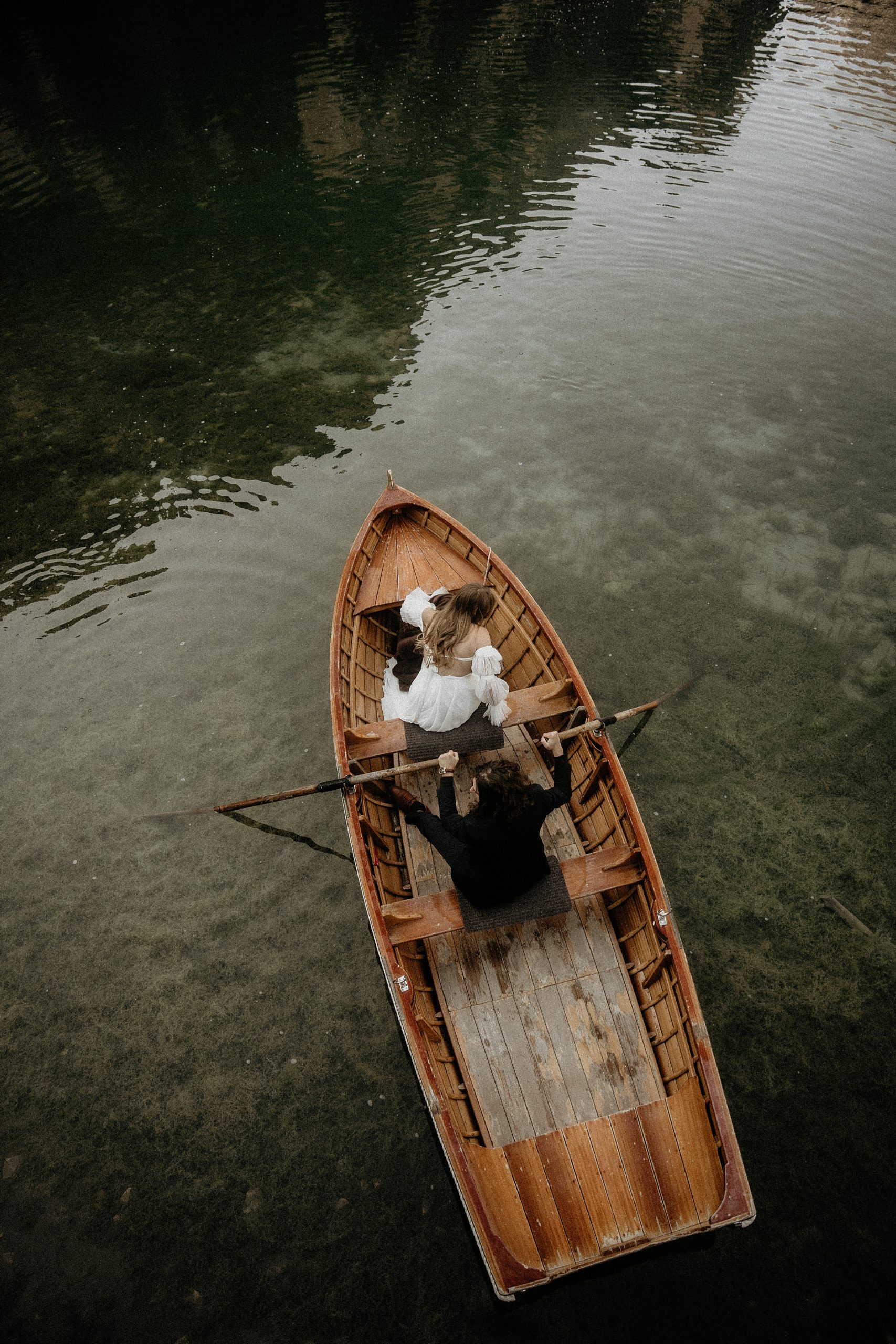 bride and groom rowing in boat