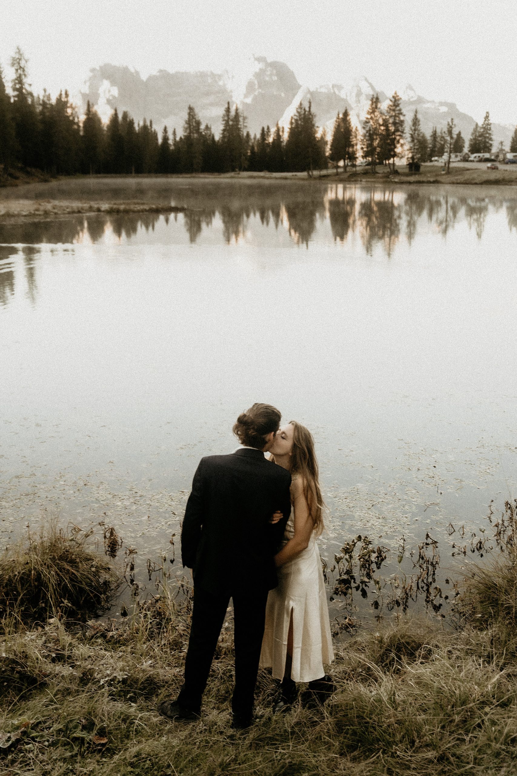 bride and groom kissing dolomites landscape


