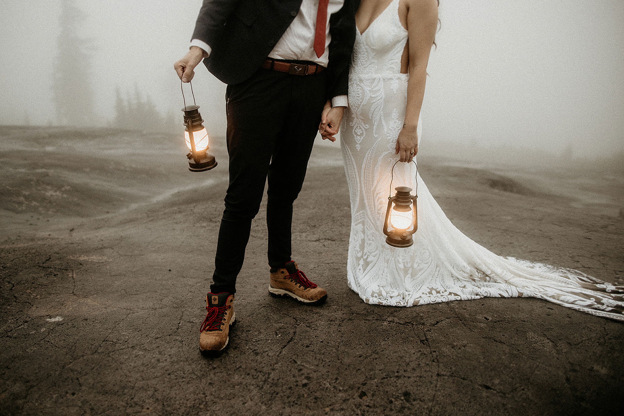 bride and groom standing together with lanterns