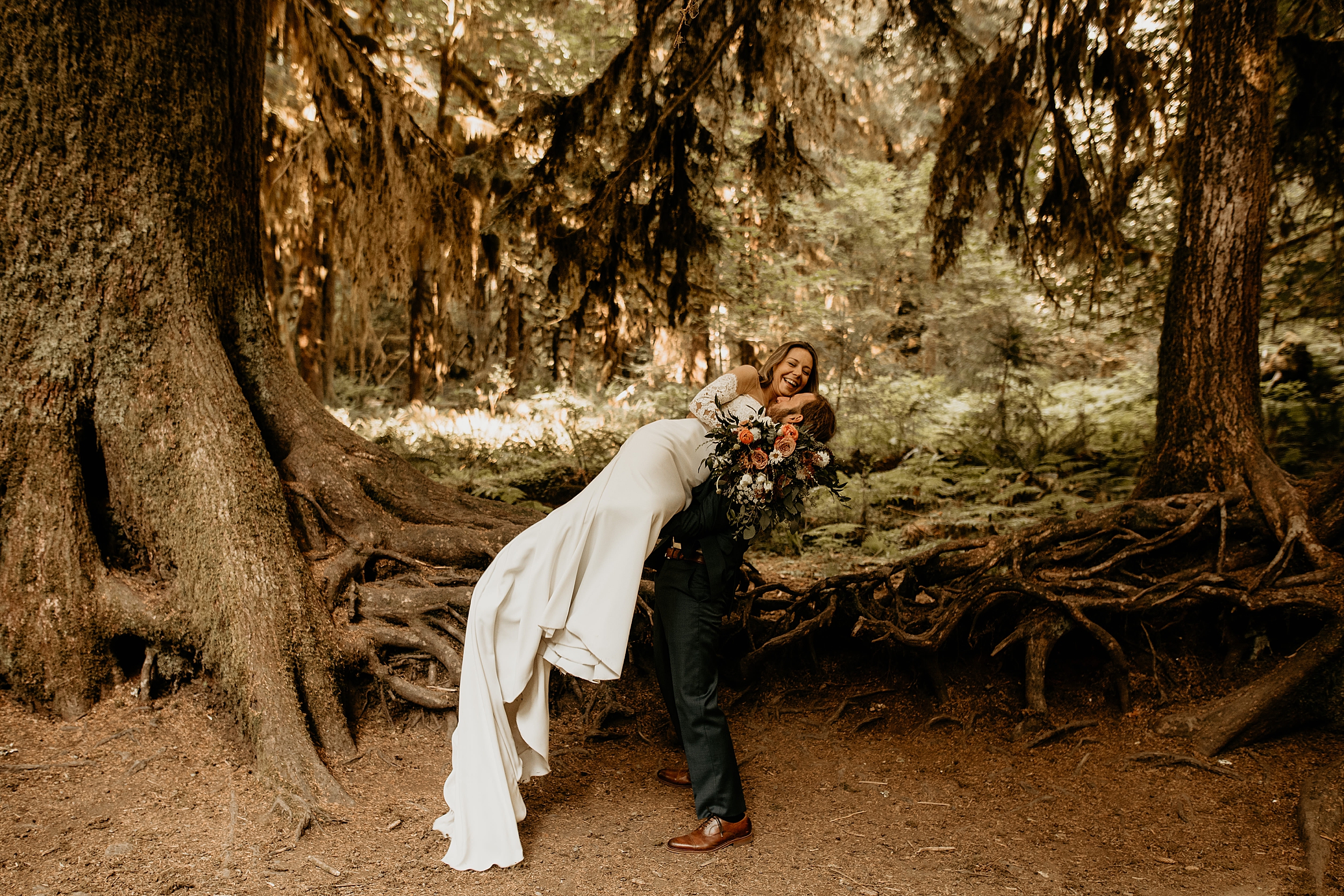 bride and groom holding each other forest landscape

