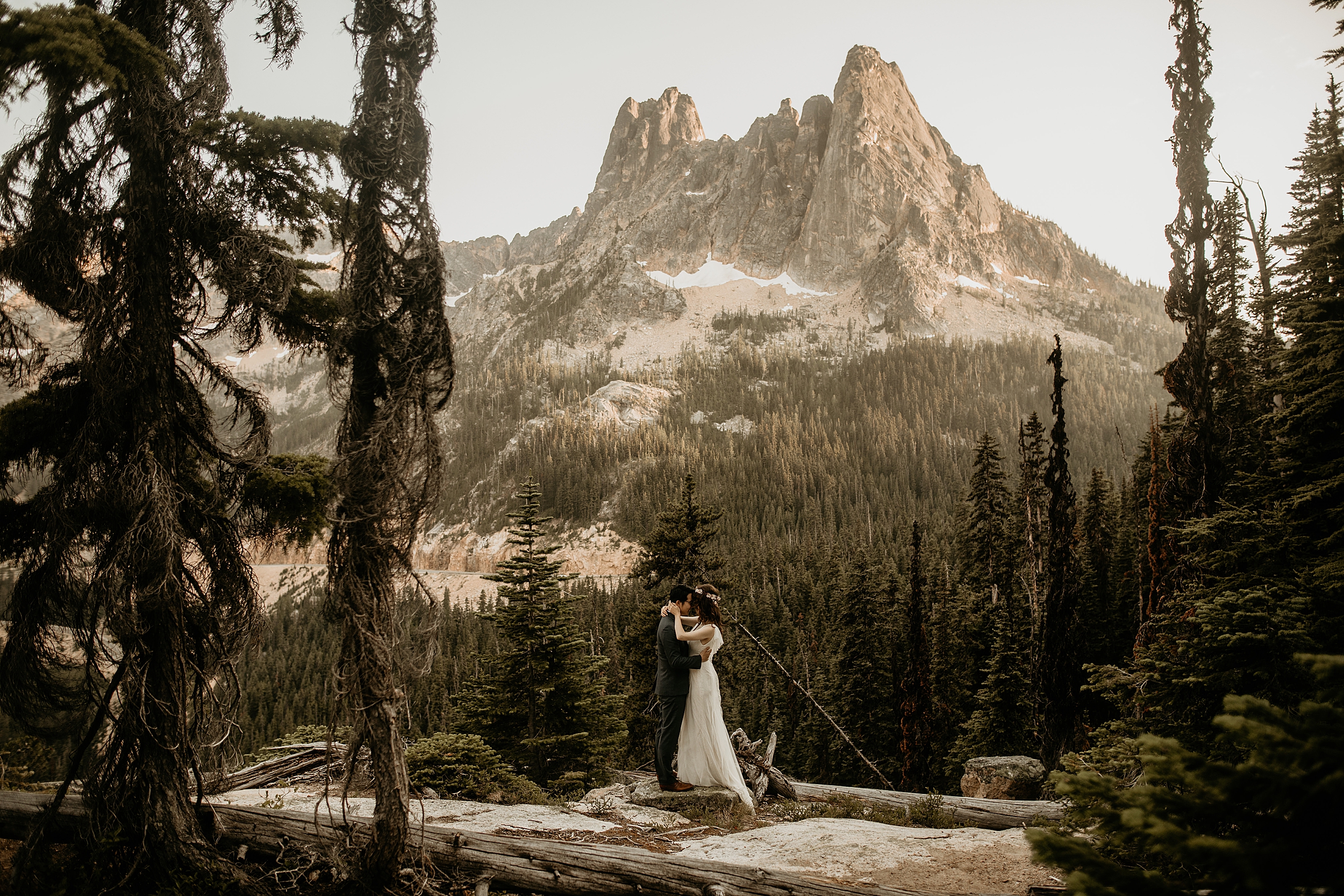 bride and groom kissing washington pass mountain landscape 
