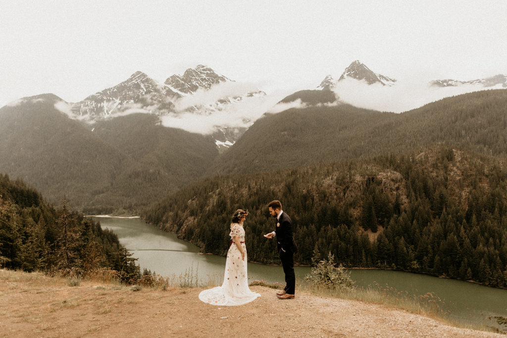 couple standing at diablo lake saying their vows 