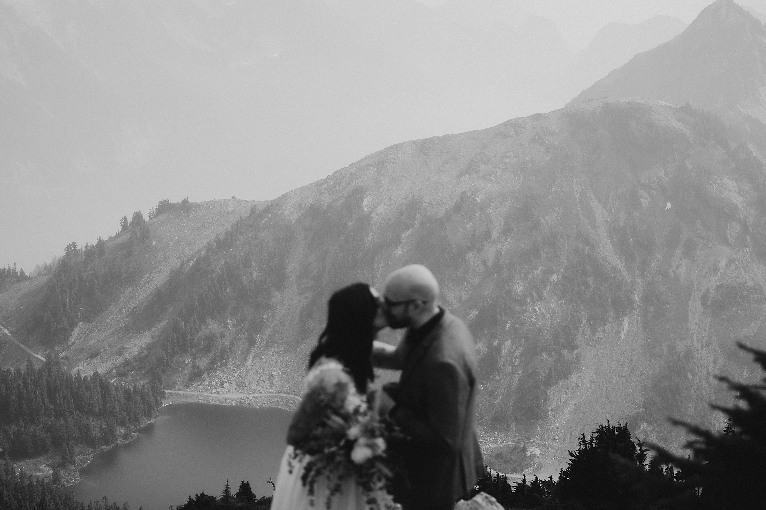 bride and groom kissing north cascades national park landscape

