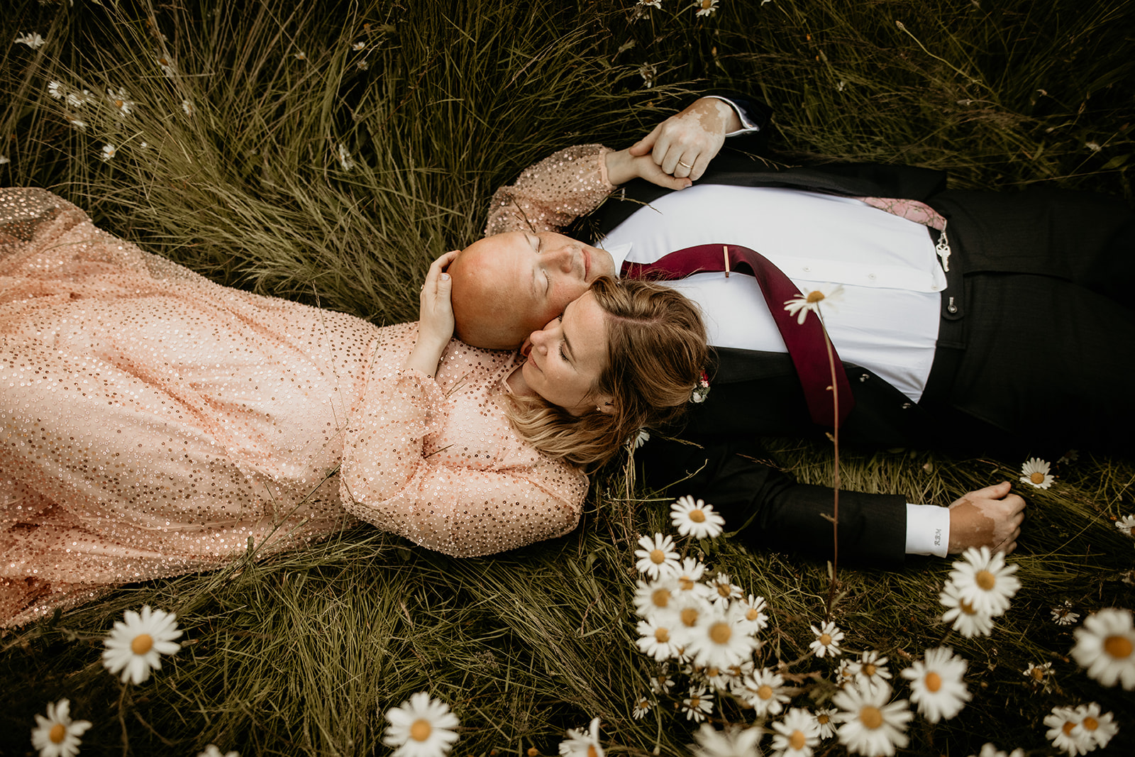 couple laying together in grass