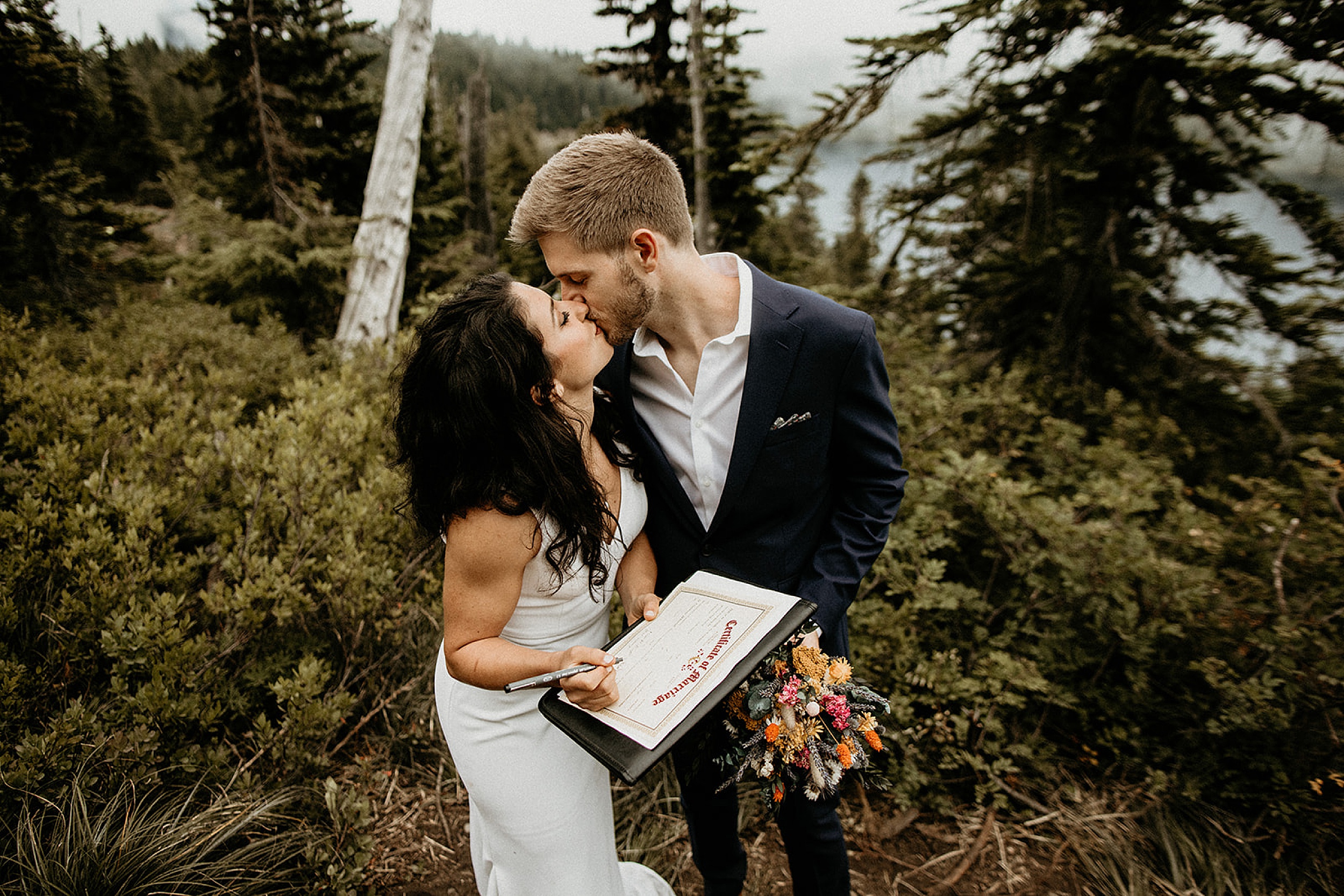 bride and groom kissing forest landscape 
