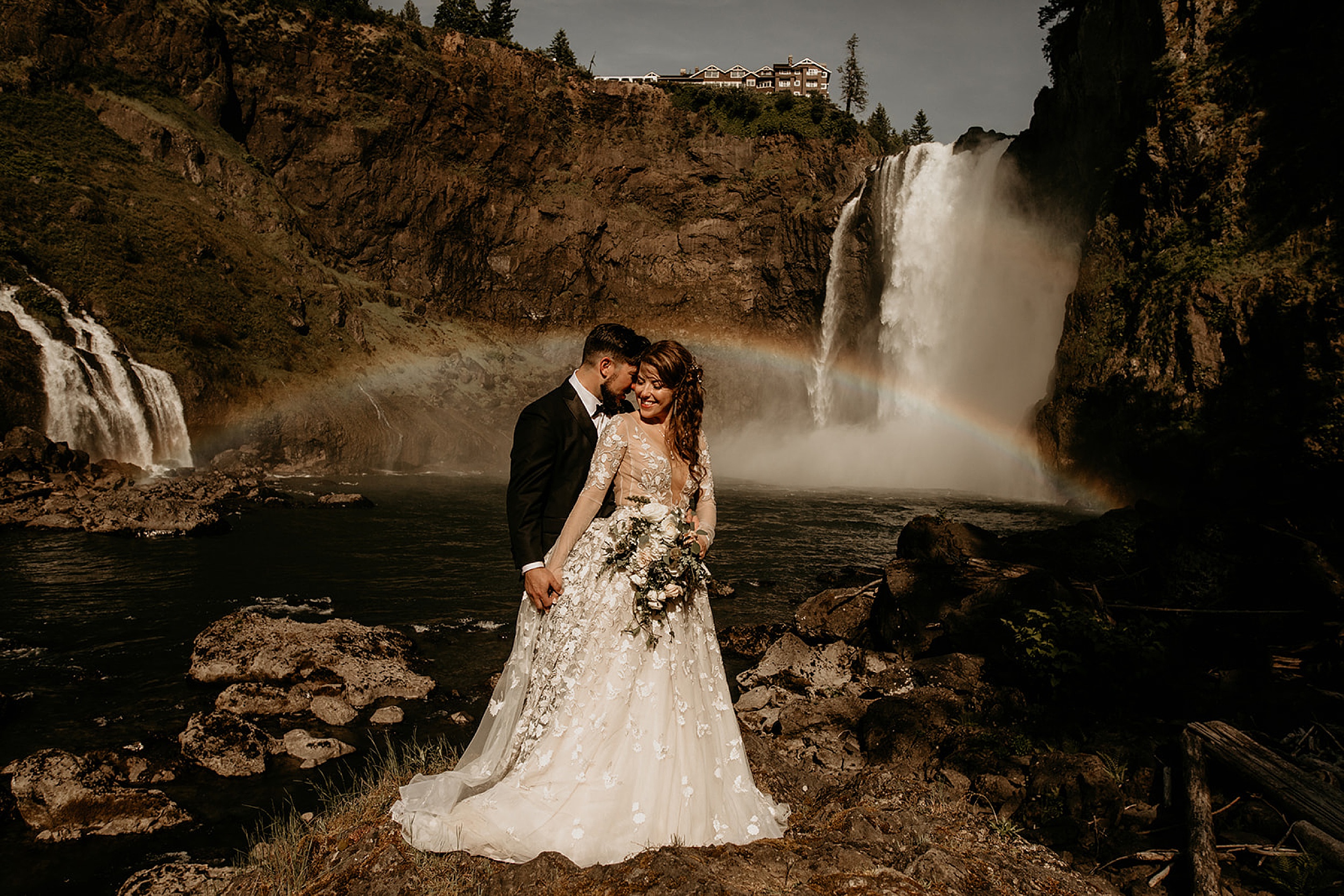 bride and groom holding each other waterfall landscape 
