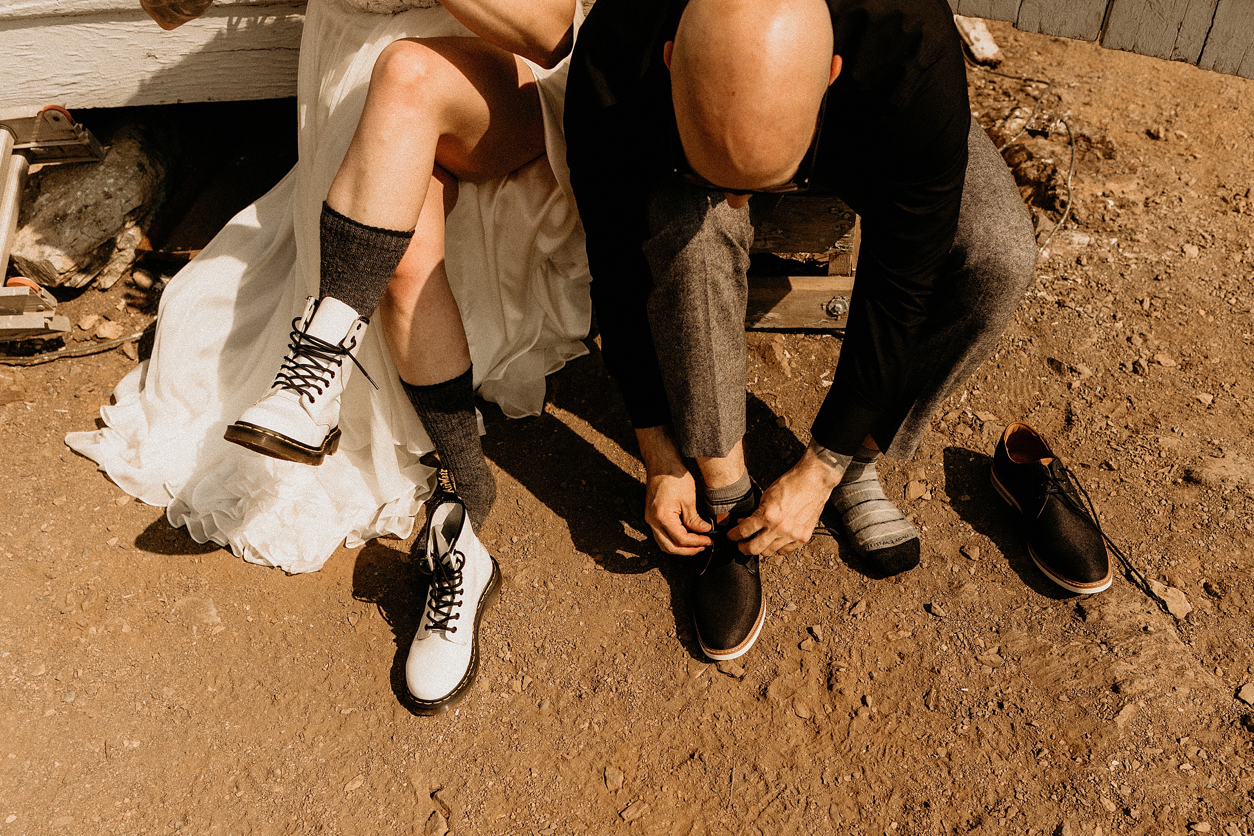bride and groom putting on shoes