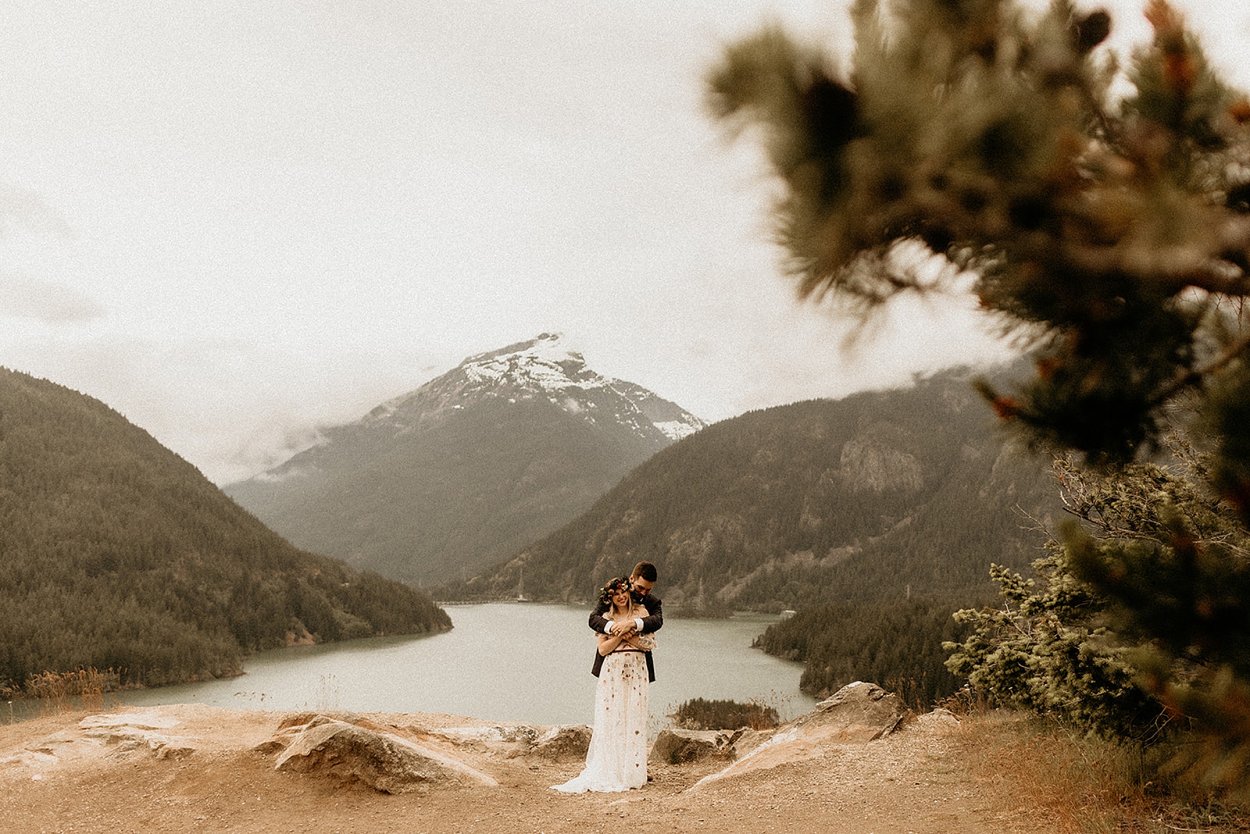 bride and groom holding each other valley landscape