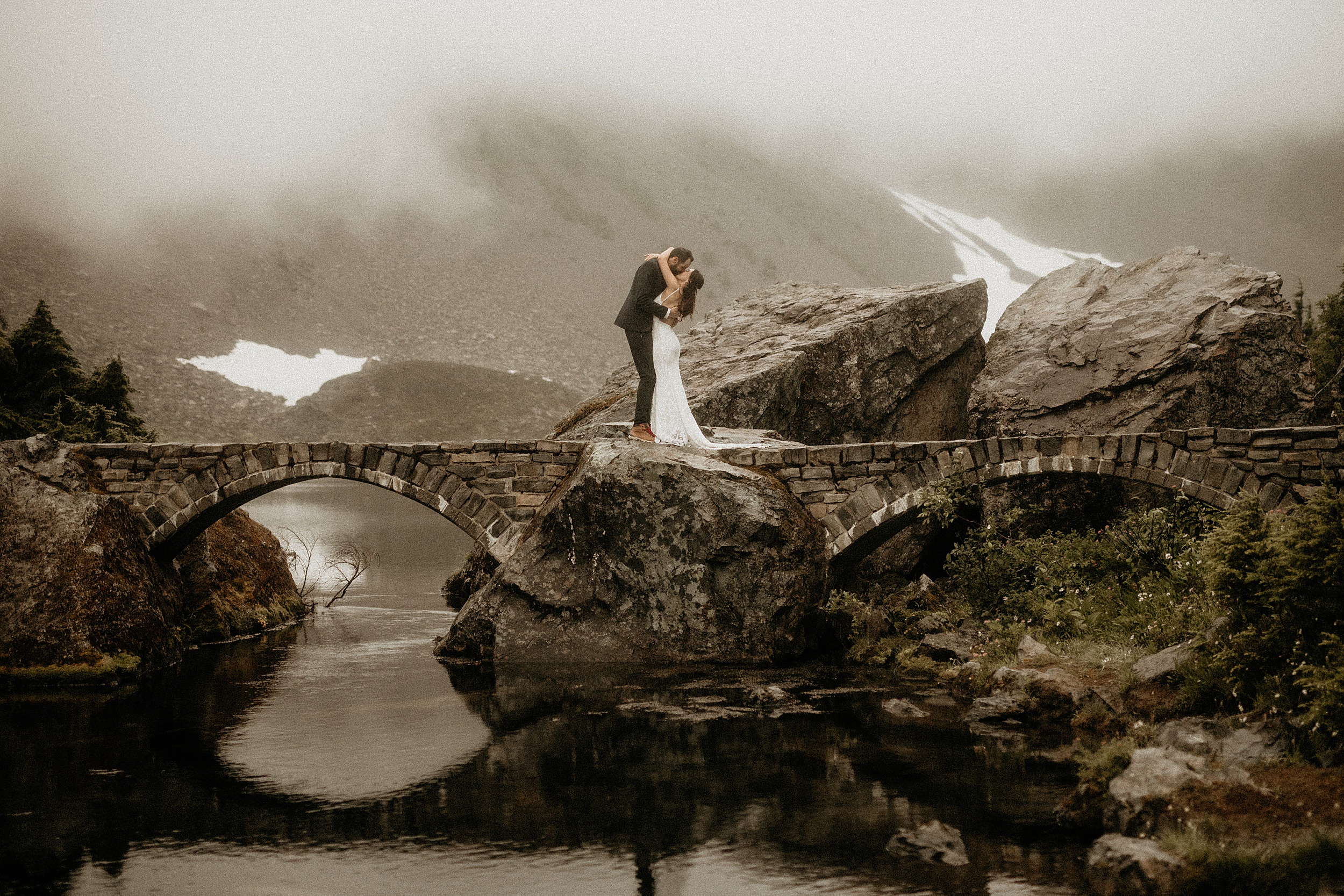 bride and groom standing together bridge 